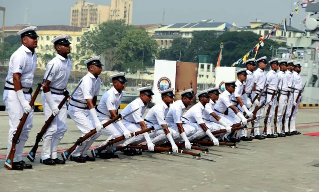 Indian Navy sailors take part in a parade as Indian President Ram Nath Kovind (not pictured) awards the President's Standard to the 22nd Missile Vessel Squadron, also known as the Killer Squadron at a ceremonial parade in Mumbai on December 8, 2021. (Photo by Sujit Jaiswal/AFP Photo)