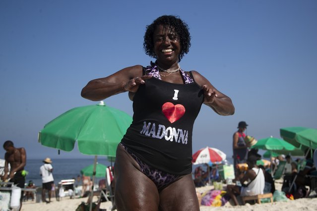 Beachgoer Elizabeth Goncalves shows off her newly bought Madonna T-shirt ahead of Madonna's concert on Copacabana beach in Rio de Janeiro, Brazil, Monday, April 29, 2024. (Photo by Bruna Prado/AP Photo)