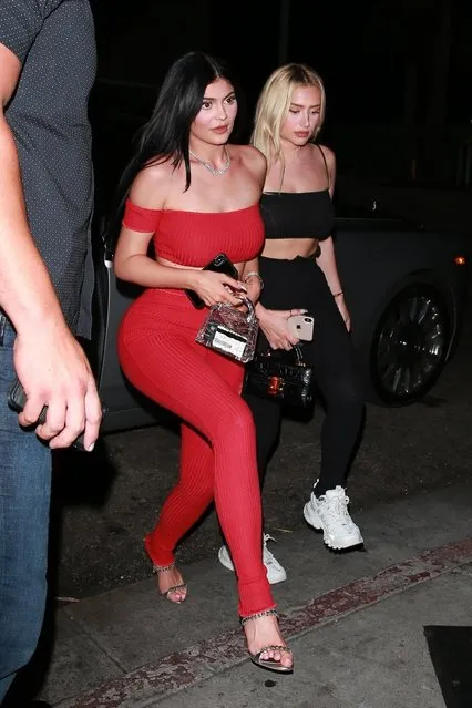 Lady in red! Kylie Jenner shows off her curves in an off the shoulder red top and red pants as she heads to the Nice Guy for an evening out with friends in West Hollywood, CA. on July 17, 2019. The cosmetics mogul coordinated her outfit with her friend who wore a similar style in black. (Photo by Backgrid USA)