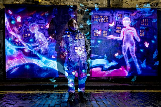 Artist Brian McFeely (aka Elph) stands alongside a multi-panel animated mural in Leith he was commissioned to create for the video game publisher Riot Games on Tuesday, April 2, 2024. Through projection the mural moves and features the character Clove, a non-binary Edinburgh resident, from the game Valorant. (Photo by Jane Barlow/PA Images via Getty Images)