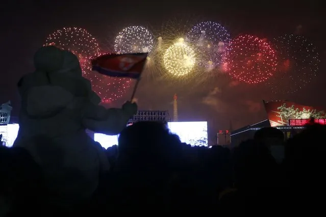 Citizens watch the fireworks celebrating the New Year on Kim Il Sung Square in Pyongyang, North Korea, Saturday, January 1, 2022. (Photo by Cha Song Ho/AP Photo)