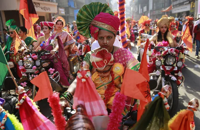 Women from India's western Maharashtra state dressed in traditional attire ride on motorcycles during a procession to celebrate “Gudi Padwa”, or the Marathi New Year, in Mumbai, India, Tuesday, March 28, 2017. (Photo by Rafiq Maqbool/AP Photo)