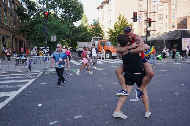 Matthew Crehan and Joey DeSanto Jones embrace after finding each other at the end of the annual LGBTQ+ Capital Pride parade in Washington on June 8, 2024. (Photo by Nathan Howard/Reuters)