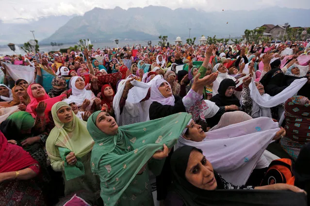 Kashmiri Muslim women pray upon seeing a relic believed to be hair from the beard of Prophet Mohammed during Meeraj-un-Nabi, a festival which marks the ascension of Prophet Mohammed to Heaven, at the Hazratbal shrine in Srinagar, May 13, 2016. (Photo by Danish Ismail/Reuters)