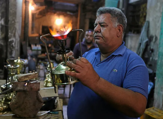 Mohamed Gamal Abdel Nasser, a workshop owner, tests primus stoves known as “Bagour” in Arabic, in Cairo, Egypt, May 11, 2016. (Photo by Mohamed Abd El Ghany/Reuters)