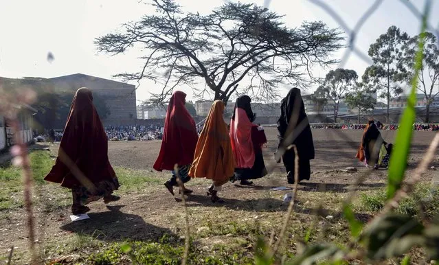 Muslim faithful arrive for the morning prayers to celebrate the first day of the Muslim holiday of Eid-al-Fitr, marking the end of the holy month of Ramadan, at the Eastleigh High School in Eastleigh, a suburb in Nairobi predominantly inhabited by Somali immigrants within Kenya's capital Nairobi, July 17, 2015. (Photo by Boniface Mwangi/Reuters)