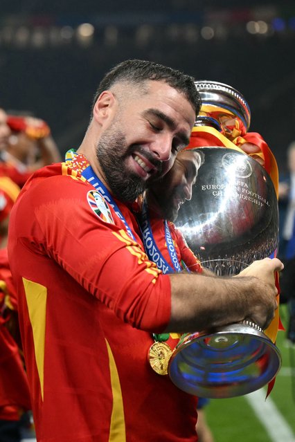 Spain's defender #02 Dani Carvajal holds the trophy after winning the UEFA Euro 2024 final football match between Spain and England at the Olympiastadion in Berlin on July 14, 2024. (Photo by Ina Fassbender/AFP Photo)