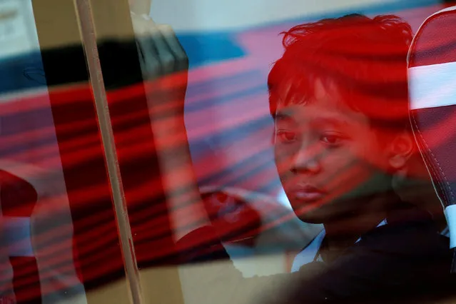 A relative of a passenger who died on Lion Air JT-610 crash at the Java sea, looks through a window as he travels on a bus after attending one-year commemoration of the crash in Jakarta, Indonesia, October 29, 2019. (Photo by Willy Kurniawan/Reuters)