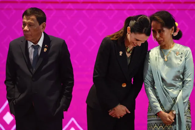 Myanmar's State Counsellor Aung San Suu Kyi (R) talks to New Zealand's Prime Minister Jacinda Ardern beside Philippines' President Rodrigo Duterte (L) during the 14th East Asia Summit in Bangkok on November 4, 2019, on the sidelines of the 35th Association of Southeast Asian Nations (ASEAN) Summit. (Photo by Manan Vatsyayana/AFP Photo)