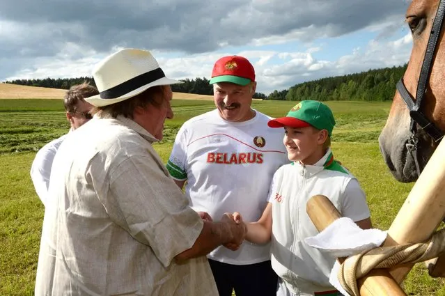 In this photo taken Wednesday, July 22, 2015, Belarus' President Alexander Lukashenko, center, looks on as his son Nikolai, left, and French actor Gerard Depardieu shake hands in the presidential residence of Ozerny, outside Minsk, Belarus. (Photo by Andrei Stasevich/BelTA Photo via AP Photo)