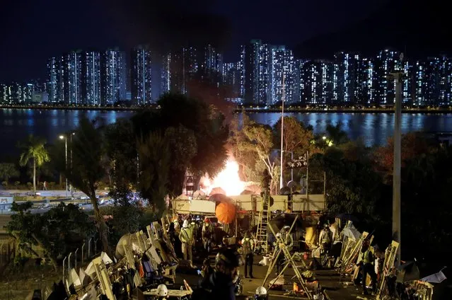 Explosives ignite an abandoned car, that were hidden there by protesters, near a barricade above the Tolo Highway next to the Chinese University campus in Hong Kong, November 15, 2019. Activists closed the highway this week, clashing with police and throwing debris and petrol bombs on the road linking the largely rural New Territories with the Kowloon peninsula to the south. (Photo by Thomas Peter/Reuters)