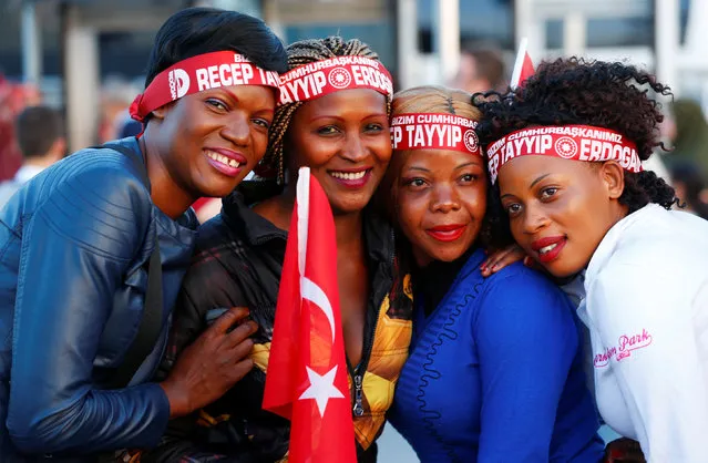 Ugandan women, supporters of Turkish President Tayyip Erdogan, pose for a photo during a rally to mark the 563rd anniversary of the conquest of the city by Ottoman Turks, in Istanbul, Turkey, May 29, 2016. The slogan on the headbands reads that “Our President Tayyip Erdogan”. (Photo by Murad Sezer/Reuters)