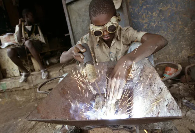 An Ivorian child welds in a wrought iron workshop in Abidjan June 15, 2005. Child labour is still prevalent across Africa, as the continent commemorates the Day of the African Child on Thursday. June 16 marked the start of an uprising by the schoolchildren of Soweto near Johannesburg in 1976 that formed a significant turning point in South Africa's struggle for liberation from apartheid. (Photo by Luc Gnago/Reuters)