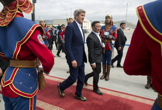 US Secretary of State John Kerry and Mongolian Foreign Minister Lundeg Purevsuren walk past an honor guard as Kerry prepares to board his airplane prior to departure from Chinggis Khaan International Airport in Ulan Bator, Mongolia, June 5, 2016, as Kerry travels to Beijing. (Photo by Saul Loeb/Reuters)