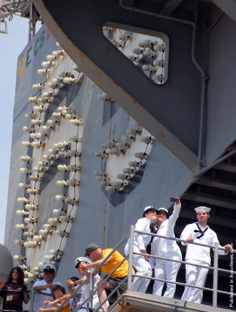 Sailors wait for the order to disembark the aircraft carrier USS Enterprise (CVN 65) as the ship returns to homeport at Naval Station Norfolk after a six-month deployment to the U.S. 5th and 6th Fleet areas of responsibility