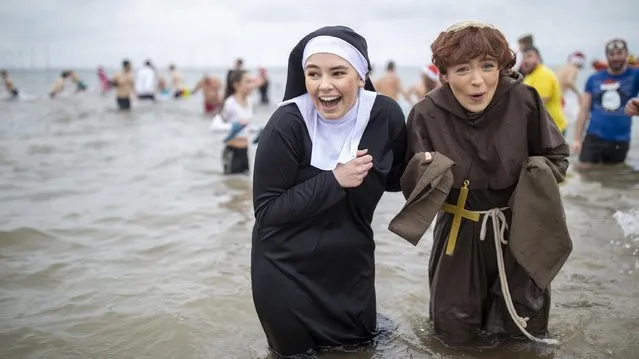 Bathers brave the cold waters of the North Sea as they take part in the annual Boxing Day dip at Redcar Beach on December 26, 2019 in Redcar, England. The event attracts hundreds of people each year who take to the cold water wearing fancy dress as they help to raise money for a number of charities. (Photo by James Glossop/The Times)