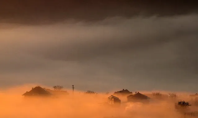 A general view of heavy fog and air pollution covering the Skopje valley in the early morning, in Skopje, North Macedonia, 16 December 2019. According to the World Health Organization (WHO), Skopje in 2018 became the most polluted capital city in Europe reaching alarmingly annual mean of high rates of fine particulate matter (PM2.5) air pollutants. (Photo by Georgi Licovski/EPA/EFE)