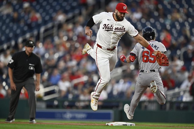 Washington Nationals first baseman Joey Gallo, center, cannot tag Atlanta Braves' Luke Williams on a throwing error during the third inning of a baseball game, Tuesday, September 10, 2024, in Washington. (Photo by John McDonnell/AP Photo)