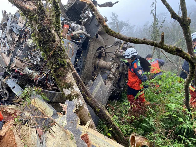 A rescue team searches for missing military officers, after a Black Hawk helicopter made a forced landing at a mountainous area near Taipei, Taiwan on January 2, 2020. The defense ministry has confirmed Taiwan's top military officer Gen. Shen Yi-ming and others were killed in a crash of an air force helicopter. (Photo by Yilan County Fire Bureau/Handout via Reuters)