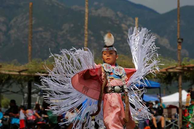 Seven-year-old Kelly Dee, who is Navajo Hopi, competes in junior girls' fancy shawl category on the second day of the 32nd Annual Taos Pueblo Pow Wow, a Native American dance competition and social gathering, in Taos, New Mexico, U.S., July 8, 2017. (Photo by Brian Snyder/Reuters)