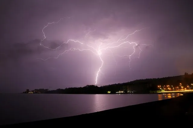 Lightning strikes are seen above Villarrica lake, in Villarrica, Chile, December 7, 2021. (Photo by Cristobal Saavedra Escobar/Reuters)