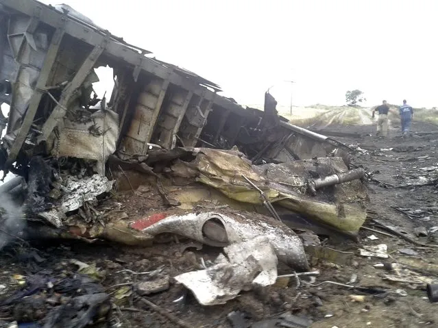The site of a Malaysia Airlines Boeing 777 plane crash is seen in the settlement of Grabovo in the Donetsk region, July 17, 2014. The Malaysian airliner MH-17 was shot down over eastern Ukraine by militants on Thursday, killing all 295 people aboard, a Ukrainian interior ministry official was quoted as saying by Interfax-Ukraine news agency. (Photo by Maxim Zmeyev/Reuters)