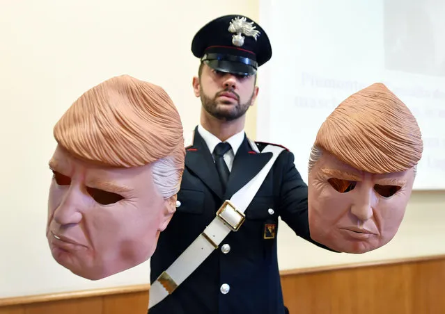 Masks of US President Donald J. Trump used by two alleged thieves are displayed by  Italian Carabinieri police during a press conference in Turin, northern Italy, 24 July 2017. Two brothers, Vittorio and Ivan Lafore, used the masks to disguise themselves as they allegedly attempted to break into ATM cash machines. The brothers were arrested on 24 July 2017 in Turin. (Photo by Alessandro Di Marco/EPA)