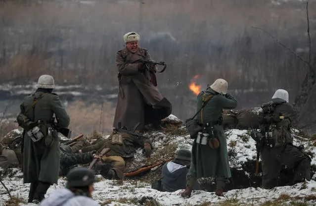 Members of a historical military club, dressed in a World War Two uniform, take part in the historical re-enactment of a battle of breakthrough of the Leningrad Siege in Gostilitsy near Saint Petersburg, Russia on January 26, 2020. (Photo by Anton Vaganov/Reuters)