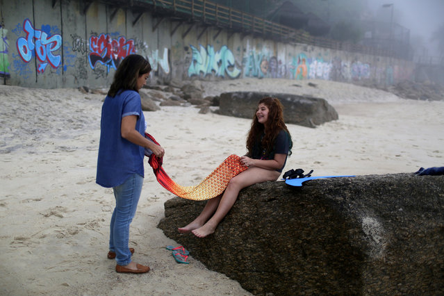 A girl prepares to take part in a mermaid lesson in Rio de Janeiro, Brazil May 28, 2017. (Photo by Pilar Olivares/Reuters)