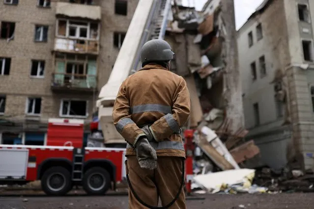 Firefighters work on removing debris after a military strike hit a building, as Russia's invasion of Ukraine continues, in Kharkiv, Ukraine on July 11, 2022. (Photo by Nacho Doce/Reuters)