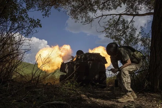 Ukrainian self-propelled artillery shoots towards Russian forces at a frontline in Kharkiv region, Ukraine, Wednesday, July 27, 2022. (Photo by Evgeniy Maloletka/AP Photo)