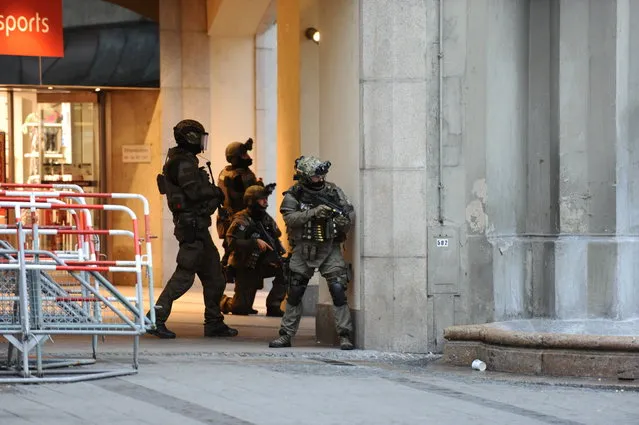 Heavily armed police forces operate at Karlsplatz (Stachus) square after a shooting in the Olympia shopping centre was reported in Munich, southern Germany, Friday, July 22, 2016. (Photo by Andreas Gebert/DPA via AP Photo)