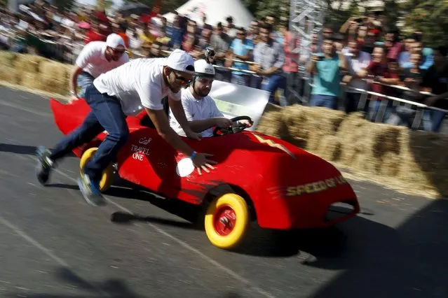 Competitors ride a homemade vehicle without an engine on a 300-metre-track during the Red Bull Soapbox Race in Amman, Jordan September 4, 2015. (Photo by Muhammad Hamed/Reuters)