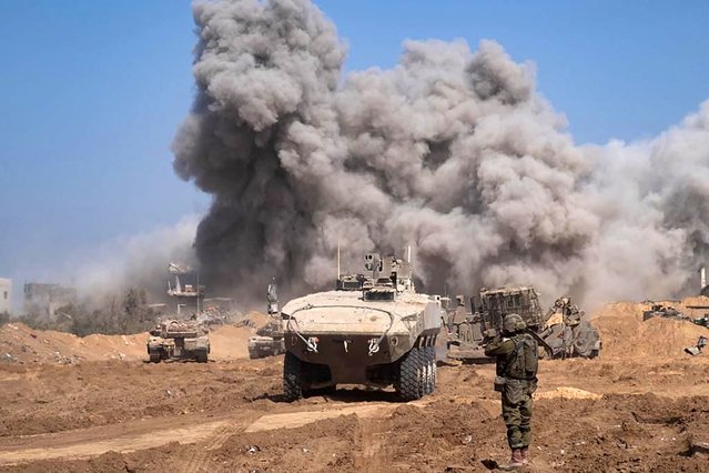 This picture released by the Israeli army on November 5, 2023, shows Israel military vehicles and heavy smoke inside the Gaza Strip as battles between Israel and the Palestinian Hamas movement continue. (Photo by Israeli Army/AFP Photo)