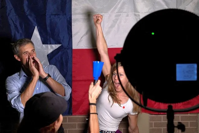 Marika Mohr, an American from Finland, raises her hand as Texas Democratic gubernatorial candidate and former U.S. congressman Beto O'Rourke shouts, “First time voter”, before posing with supporters in front of the Texas state flag during a campaign event in Houston, Texas, U.S. September 13, 2022. (Photo by Adrees Latif/Reuters)
