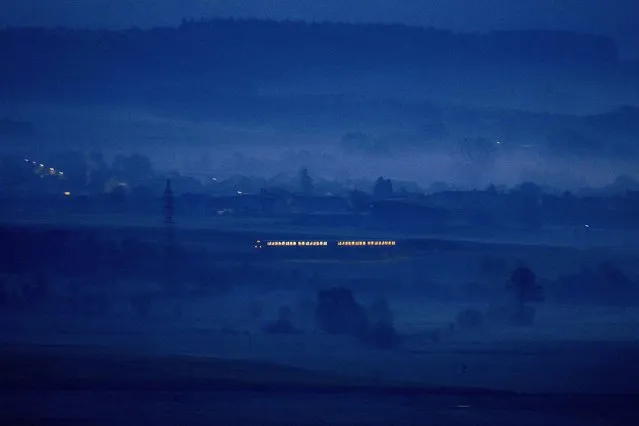 A regional train travels through the outskirts of Frankfurt, Germany, on a misty Thursday morning, April 28, 2022. (Photo by Michael Probst/AP Photo)