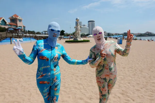 Women wearing facekinis pose for the camera as they visit a beach in Qingdao, Shandong Province, China, August 16, 2016. (Photo by Reuters/Stringer)