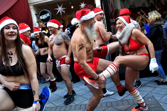 People take part in a half naked Santa run in downtown Budapest, Hungary, December 10, 2017. (Photo by Bernadett Szabo/Reuters)