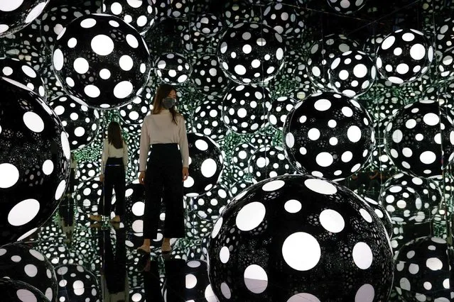 A visitor looks at an installation by the artist Yayoi Kusama during a media preview of the Yayoi Kusama: 1945 to Now exhibition in Hong Kong, China on October 9, 2022. (Photo by Tyrone Siu/Reuters)