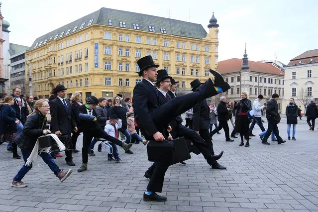 More than 300 people dressed in costumes perform the cult comedy Monty Python's Silly Walk on January 7 in Brno, Czech Republic, marking the International Silly Walk Day. (Photo by Radek Mica/AFP Photo)