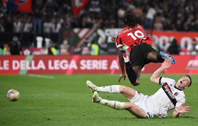 AC Milan's Portuguese forward #10 Rafael Leao is challenged by Bologna's Scottish midfielder #19 Lewis Ferguson during the Italian Cup (Coppa Italia) final football match between AC Milan and Bologna at the Olympic stadium in Rome, on May 14, 2025. (Photo by Isabella Bonotto/AFP Photo)