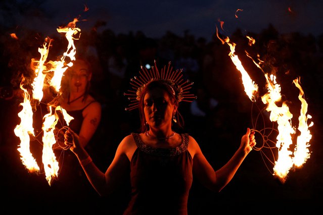 A fire dancer performs at the Bealtaine fire festival, marking the beginning of summer at the Hill of Uisneach in Rathnew, Ireland, on May 10, 2025. (Photo by Clodagh Kilcoyne/Reuters)