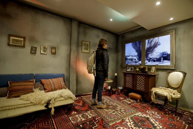 A woman watches a video of an explosion as she stands inside a mock-up Syrian home, set up by Amnesty International inside a subway station, in Buenos Aires, Argentina, Monday, September 19, 2016. Argentina's President Mauricio Macri pledged earlier in the year that the country would receive 3,000 Syrian refugees. (Photo by Victor R. Caivano/AP Photo)