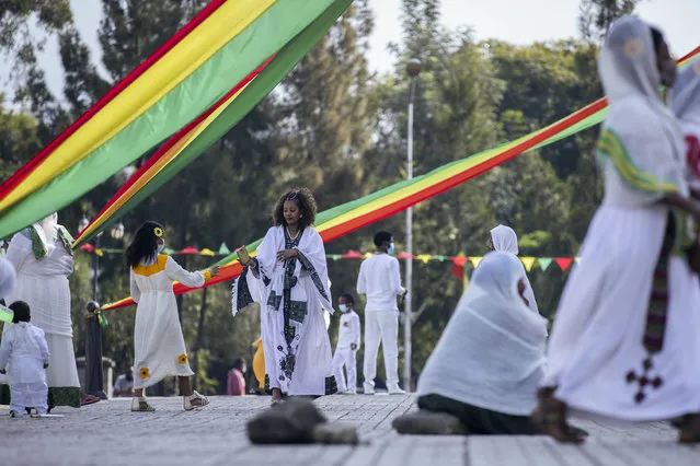 Ethiopian Orthodox faithful attend a prayer ceremony to mark the holiday of “Enkutatash”, the first day of the new year in the Ethiopian calendar, which is traditionally associated with the return of the Queen of Sheba to Ethiopia some 3,000 years ago, at Bole Medhane Alem Ethiopian Orthodox Cathedral in the capital Addis Ababa, Ethiopia Friday, September 11, 2020. (Photo by Mulugeta Ayene/AP Photo)