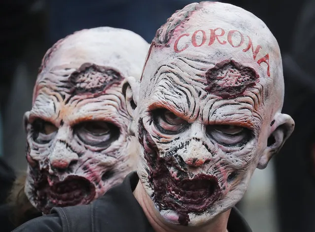 People wearing masks take part in a “We Do Not Consent” rally at Trafalgar Square, organised by Stop New Normal, to protest against coronavirus restrictions, in London, Saturday, September 26, 2020. (Photo by Frank Augstein/AP Photo)