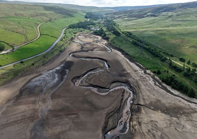 A drone view shows vehicles driving along a road next to a dry section of the Woodhead Reservoir after a prolonged period without rain saw water levels drop near Tintwistle, Britain, on June 16, 2025. (Photo by Phil Noble/Reuters)