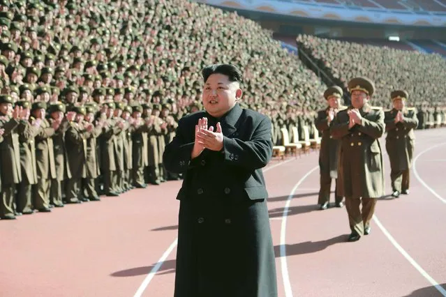 North Korean leader Kim Jong-un (C) claps during a photo session with the participants of a meeting of military and political cadres in this undated photo released by North Korea's Korean Central News Agency (KCNA) in Pyongyang February 2, 2015. (Photo by Reuters/KCNA)