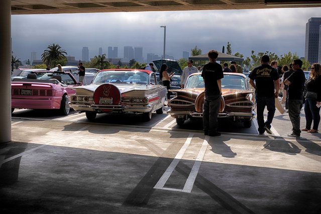 Visitors to the Petersen Automotive Museum view lowrider cars at the kickoff to “Best in Low: Lowrider Icons of the Street and Show”, a new lowrider exhibit Saturday, May 11, 2024, in Los Angeles. The exhibit will be open through April 2025. (Photo by Richard Vogel/AP Photo)