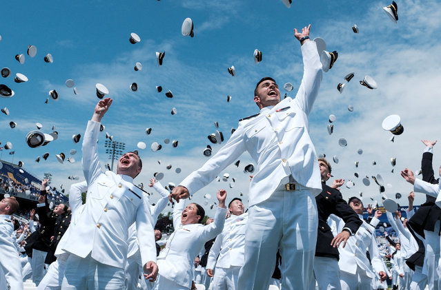 Midshipmen toss their caps into the air as they celebrate during the commissioning and graduation ceremony at the U.S. Naval Academy in Annapolis, Maryland, U.S., May 24, 2024. (Photo by Michael A. McCoy/Reuters)