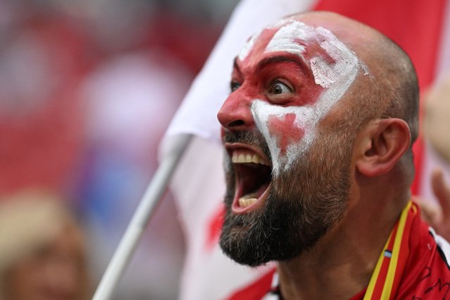 A Georgia's supporter wearing a make up in the color of the Georgian flag reacts ahead of the UEFA Euro 2024 round of 16 football match between Spain and Georgia at the Cologne Stadium in Cologne on June 30, 2024. Spain dominated the lowest-ranked team in the tournament and outscored Georgia 4-1. (Photo by Kirill Kudryavtsev/AFP Photo)
